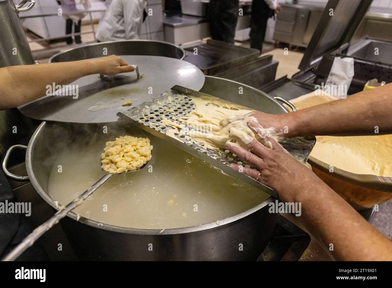 Zubereitung von Eiern in der Restaurantküche. Geriebene Eiertropfennudeln Stockfoto