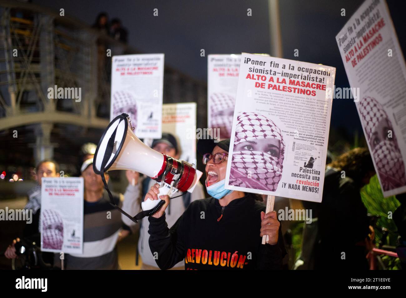 Anhänger Palästinas sammeln sich am 10. Oktober 2023 vor der israelischen Botschaft in Bogota, Kolumbien, indem sie palästinensische Fahnen und Banner schwenken. Stockfoto