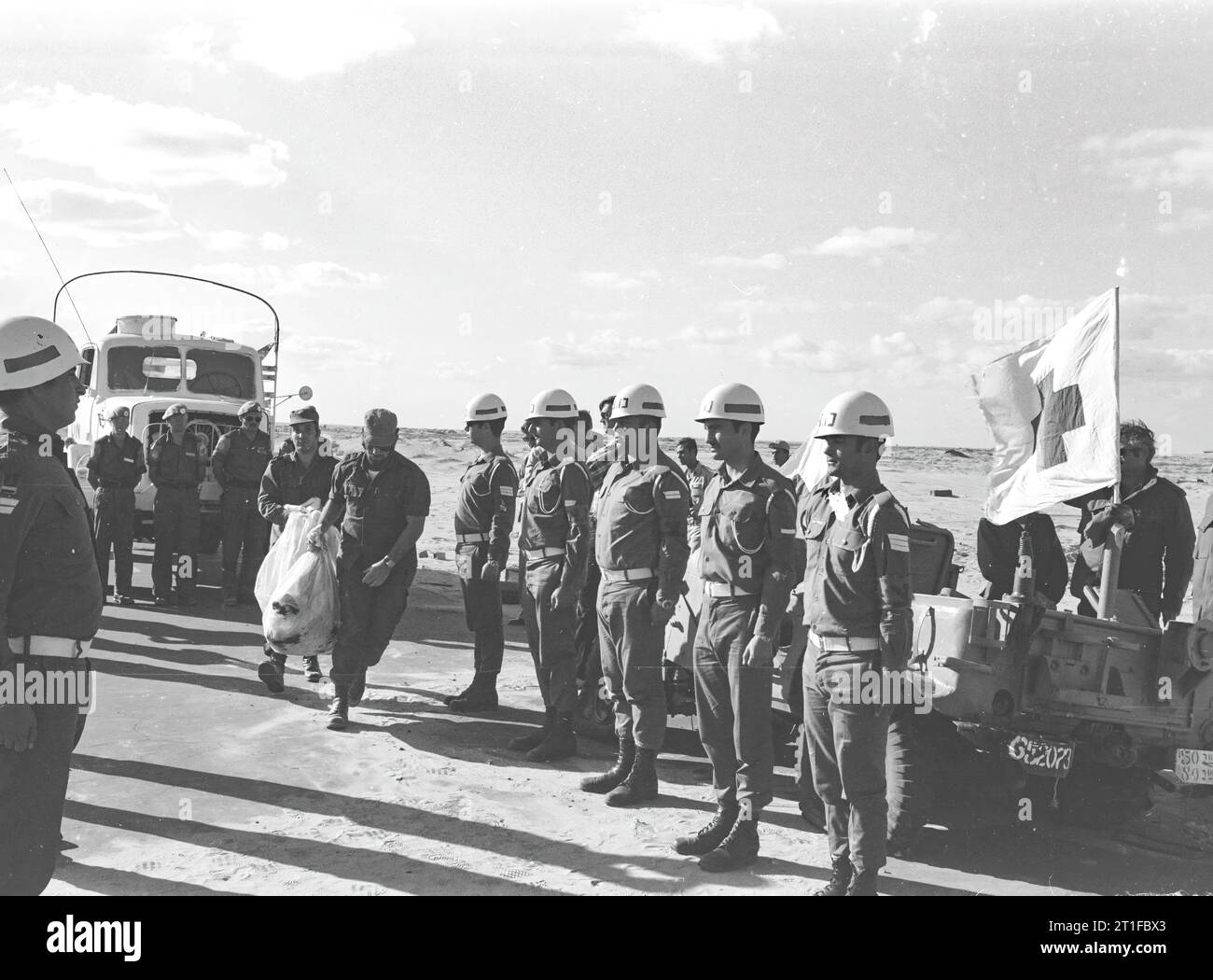 JOM KIPPUR WAR. ISRAELISCHE SOLDATEN MIT DEM ÜBERRESTE EINES ISRAELISCHEN SOLDATEN WÄHREND DES LEICHNAM-AUSTAUSCHS AUF DER STRASSE BALUZA-KANTARA. Stockfoto