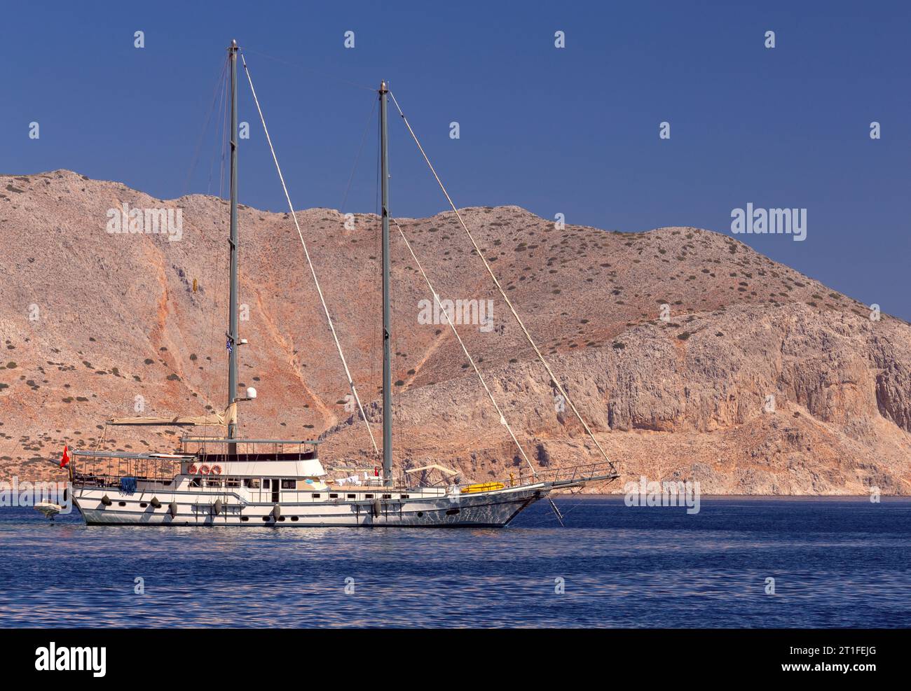 Weiße Vergnügungsyacht in der Bucht der Insel Symi an einem hellen sonnigen Tag. Simi. Griechenland. Stockfoto