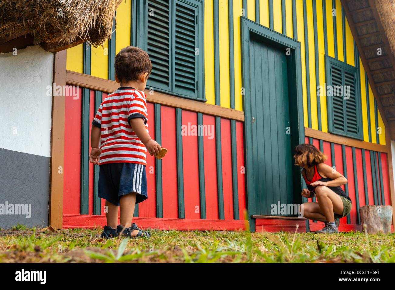 Mutter und Sohn spielen in einem traditionellen madeirischen Haus wie in Santana im Wald von Caldeirao Verde, Santana Stockfoto