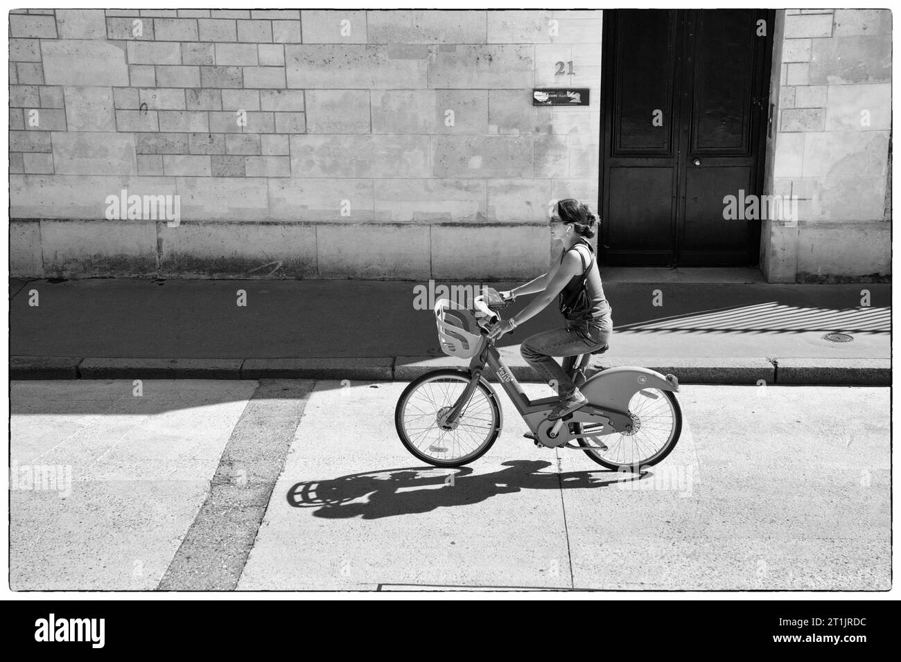 Frau, die ihr Fahrrad auf der Straße in St. fährt Germain, Paris Frankreich Stockfoto