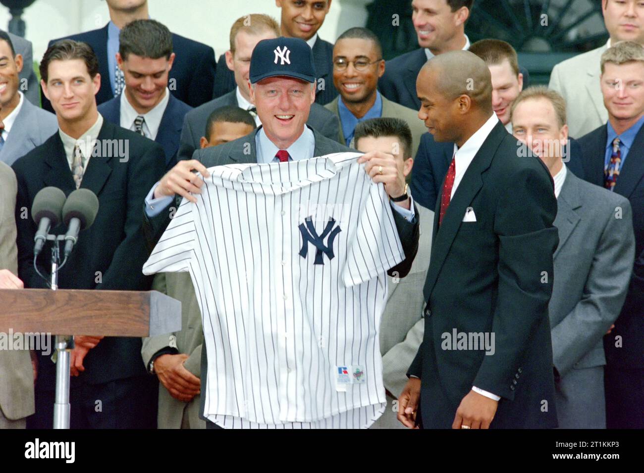 US-Präsident Bill Clinton hält ein New York Yankee Baseballtrikot hoch, das ihm der kubanische Überläufer, Pitcher Orlando 'El Duque' Hernandez, während einer Zeremonie zu Ehren des World Series Champion 1998 New York Yankees auf dem Südrasen des Weißen Hauses, am 10. Juni 1999 in Washington, D.C. gegeben hat Stockfoto