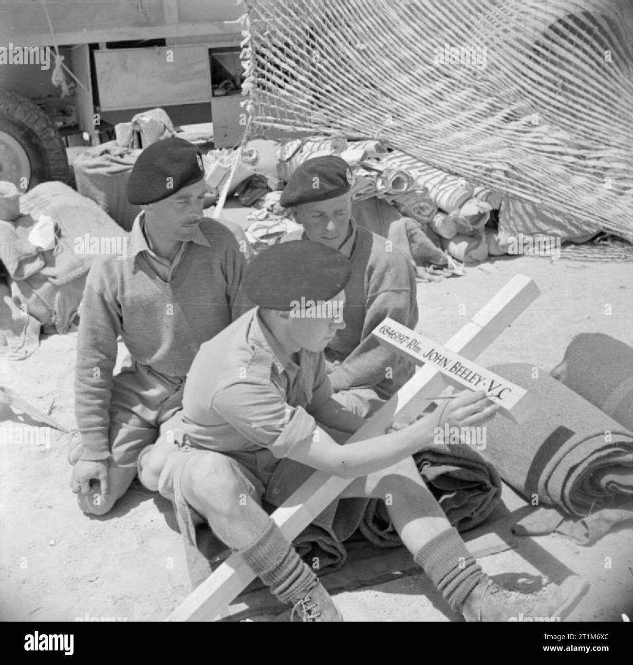 Der britischen Armee in Nordafrika 1942 Kameraden der Rifleman Johannes Beeley VC 1 King's Royal Rifle Corps, der posthum eine Victoria Cross in der Schlacht von Sidi Rezegh am 21. November 1941 ausgezeichnet wurde, bei der Arbeit an einem Kreuz über sein Grab gestellt werden, 22. Mai 1942. Stockfoto
