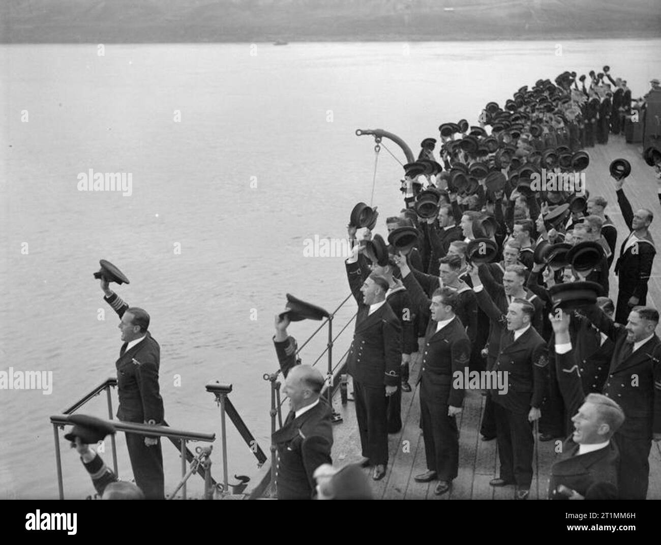 Die Royal Navy während des Zweiten Weltkriegs der kommandierende Offizier der Beifall für den HM König George VI, an Bord der Kreuzer HMS PHOEBE, Teil der Home Fleet in Scapa Flow. Stockfoto