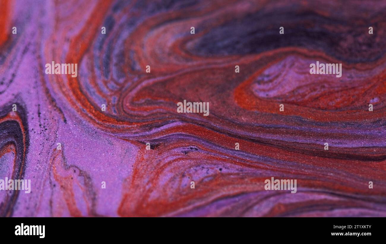 Abstrakter Hintergrund Glitzertinte rot schwarz lila Stockfoto