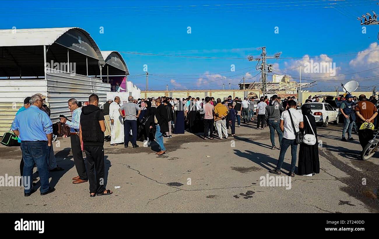 Menschen, einschließlich derjenigen, die ausländische Pässe besitzen, warten am Rafah-Übergang, mit der Hoffnung, am Montag, den 16. Oktober 2023, nach Ägypten zu reisen. Nach dem Beginn des Konflikts zwischen Israel und der Hamas am 7. Oktober 2023 wurde Rafah Crossing aufgrund anhaltender israelischer Bombardements geschlossen. Ägypten behauptet, dass seine eigene Seite des Grenzübergangs weiterhin funktioniert, aber die israelischen Luftangriffe haben erhebliche Schäden an der Infrastruktur auf palästinensischer Seite verursacht. Der Rafah Crossing befindet sich im südlichen Gazastreifen, grenzt an die ägyptische Sinai-Halbinsel und stellt das einzige A dar Stockfoto