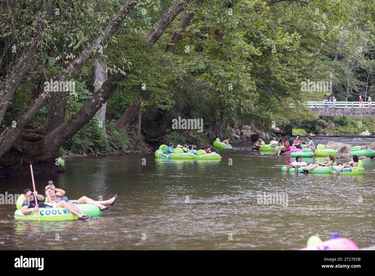 Helen, GA / USA - 9. September 2023: Tele-Ansicht zeigt Menschen, die an einem heißen Sommertag auf dem Chattahoochee River Tubing machen. Stockfoto