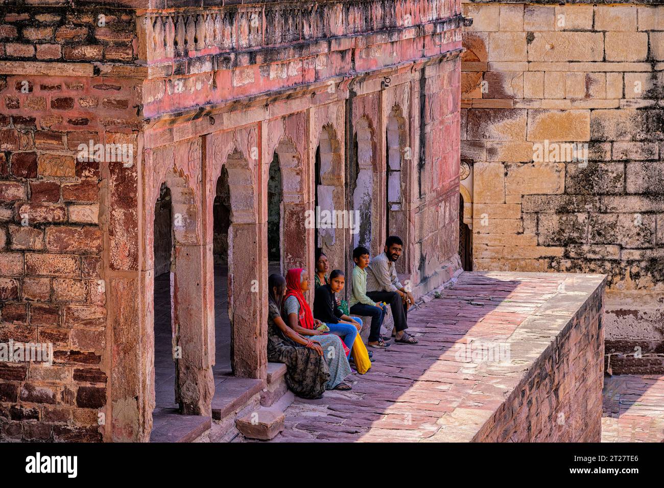Ortsansässige Touristen ruhen in der Nähe des Fateh Pol Tores im Mehrangarh Fort, Jodhpur Stockfoto