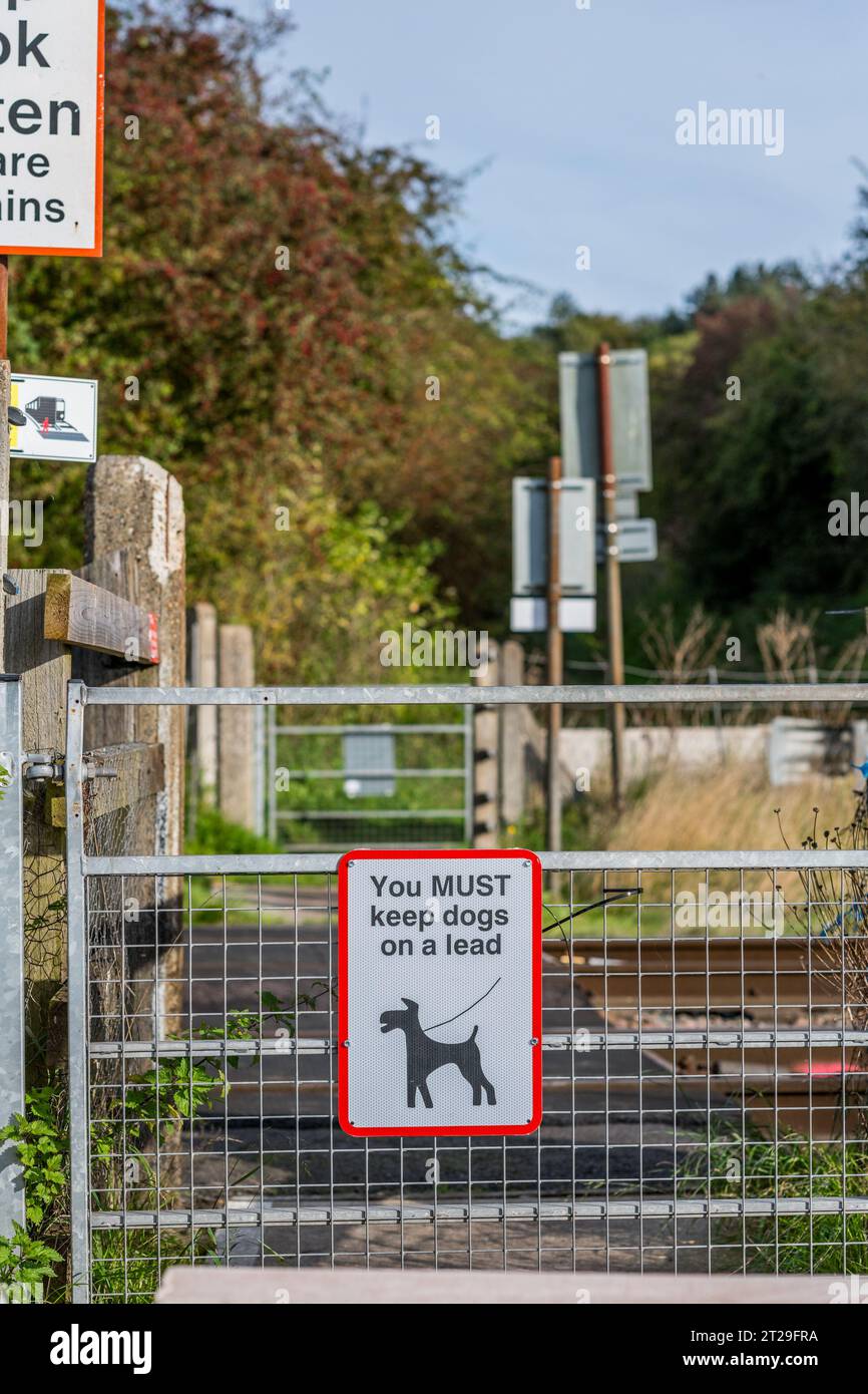 Sie müssen Hunde auf der Spur halten, Warnschilder an Bahnübergängen auf der East Coast Mainline Railway. Stockfoto