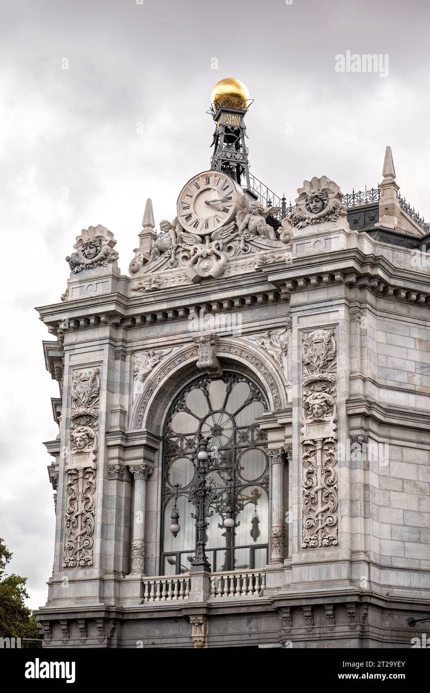 Detail der Fassade des Gebäudes der Bank of Spain mit seiner Uhr und einer goldenen Kugel Stockfoto
