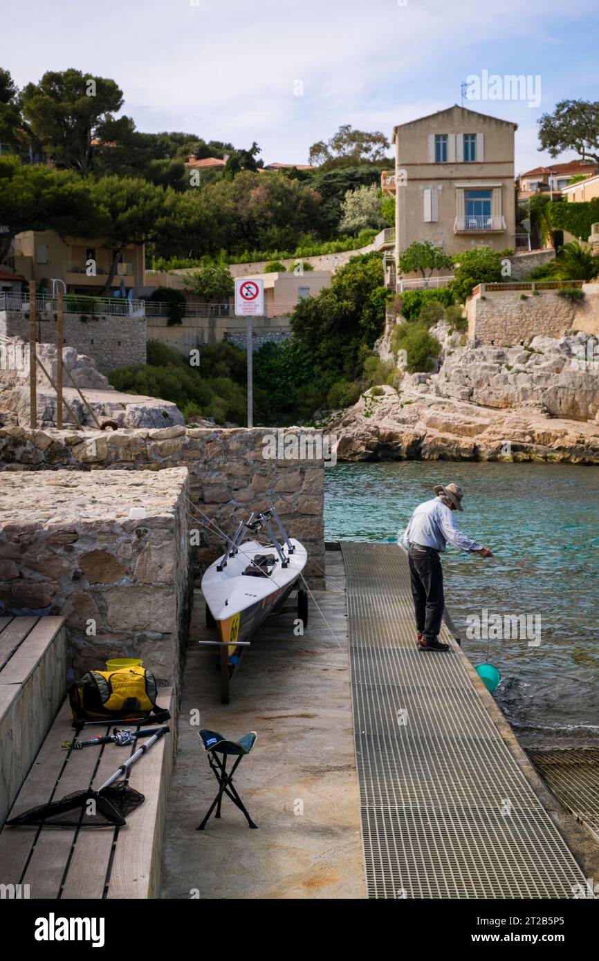 Ein einsamer Mann fischt im Hafen von Cassis, Südfrankreich. Stockfoto