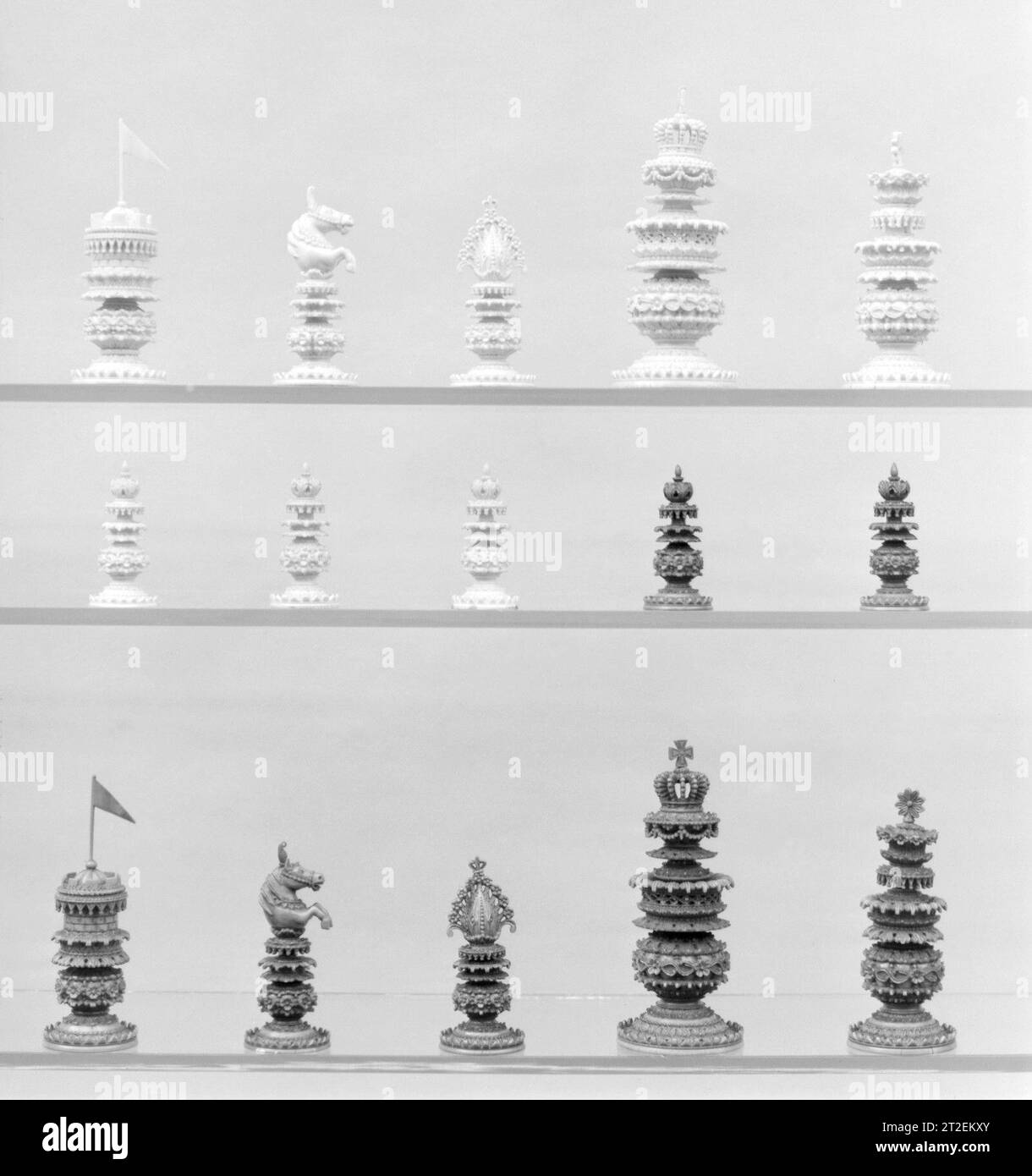 Schachmänner (32) Indianer, für den europäischen Markt 19. Jahrhundert auf hohen dekorativen Podesten sind die Könige durch eine kaiserliche Krone gekennzeichnet, Bischöfe durch Mitren, Ritter die Vorderteile der Pferde, Türme mit Flagge. Stockfoto