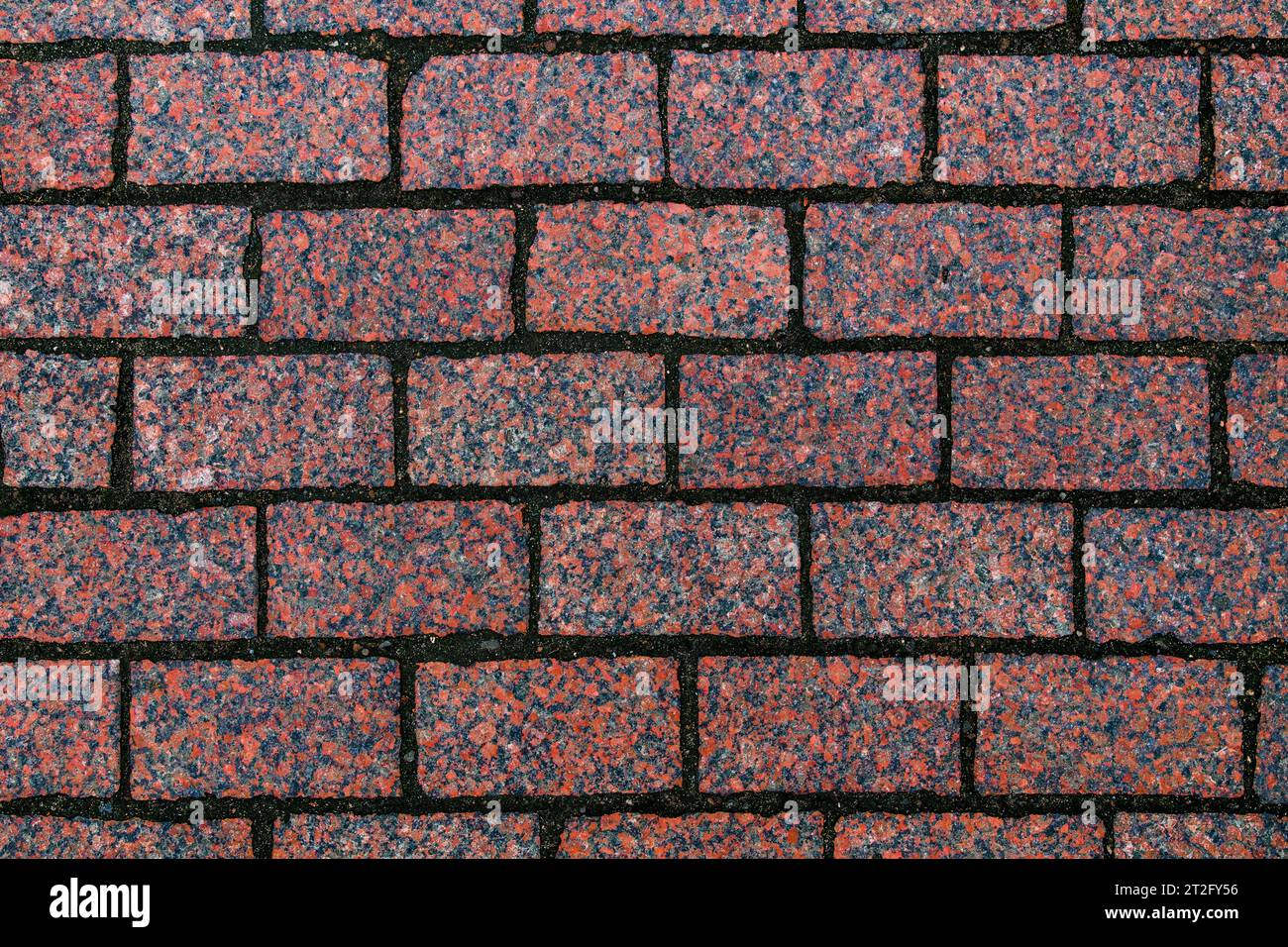 Hintergrund der roten Granitziegel Stockfoto