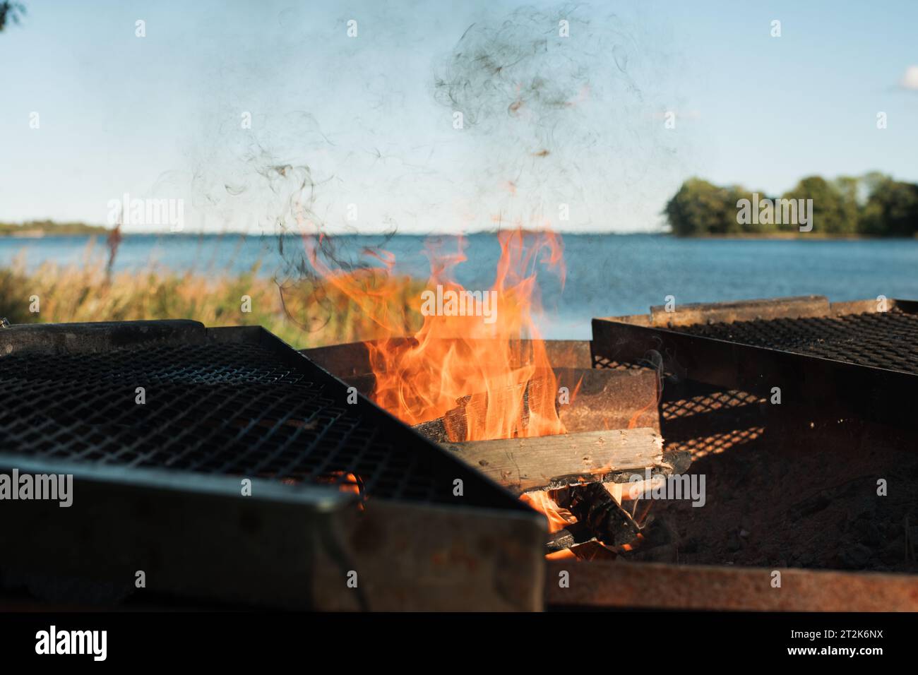 Helles Feuer in einer Feuerstelle am Strand in Schweden Stockfoto