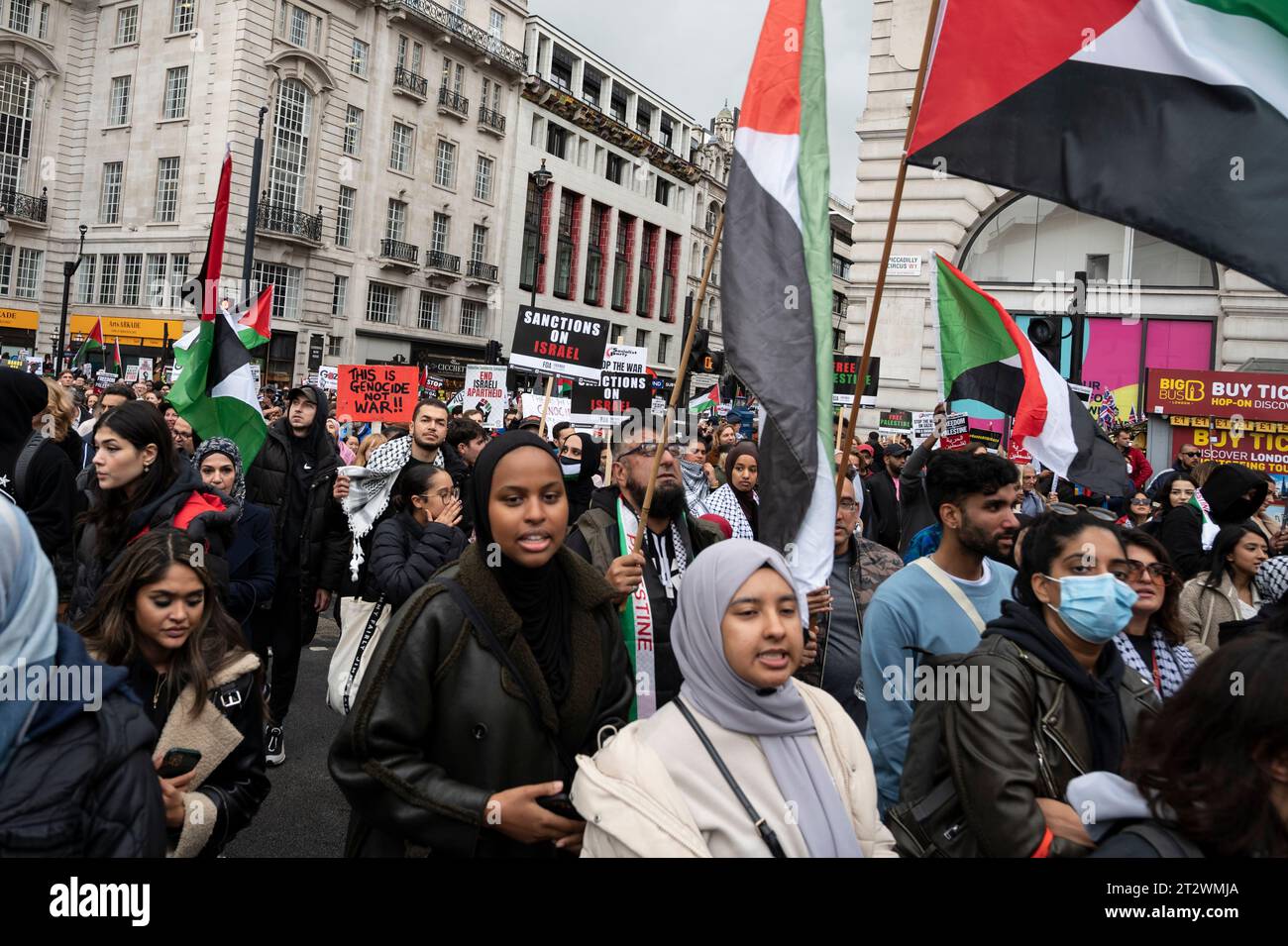 Demonstranten gegen die Bombardierung des Gazastreifens mit palästinensischen Flaggen und Plakaten mit der Aufschrift "das ist Völkermord, nicht Krieg" und "Sanktionen gegen Israel". London. Stockfoto