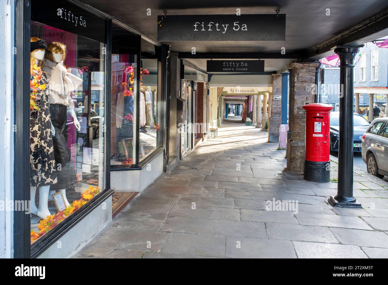 Geschäfte unter einem Fußweg entlang der High Street. Totnes, Devon, England Stockfoto