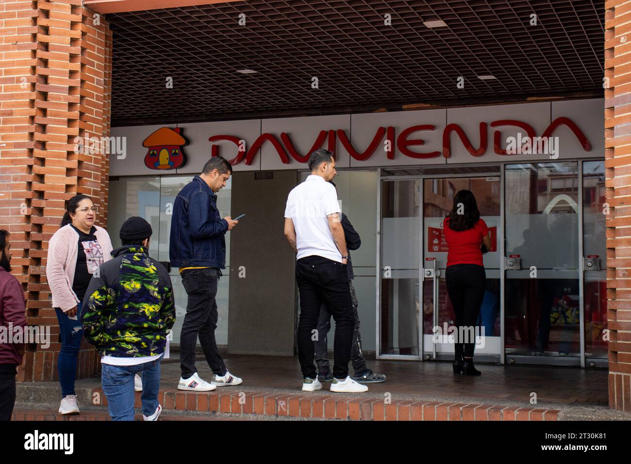 Bogota, Kolumbien - 21. Oktober 2023. Leute warten in der Schlange am Eingang der Davivienda Bank in Bogota. Finanzkonzept Stockfoto