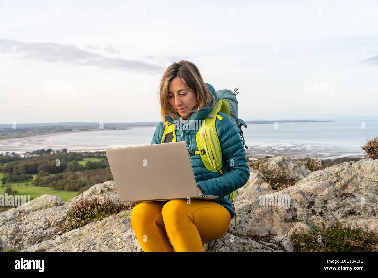 Digitale Nomade Backpackerin, die draußen mit ihrem Computer arbeitet Stockfoto