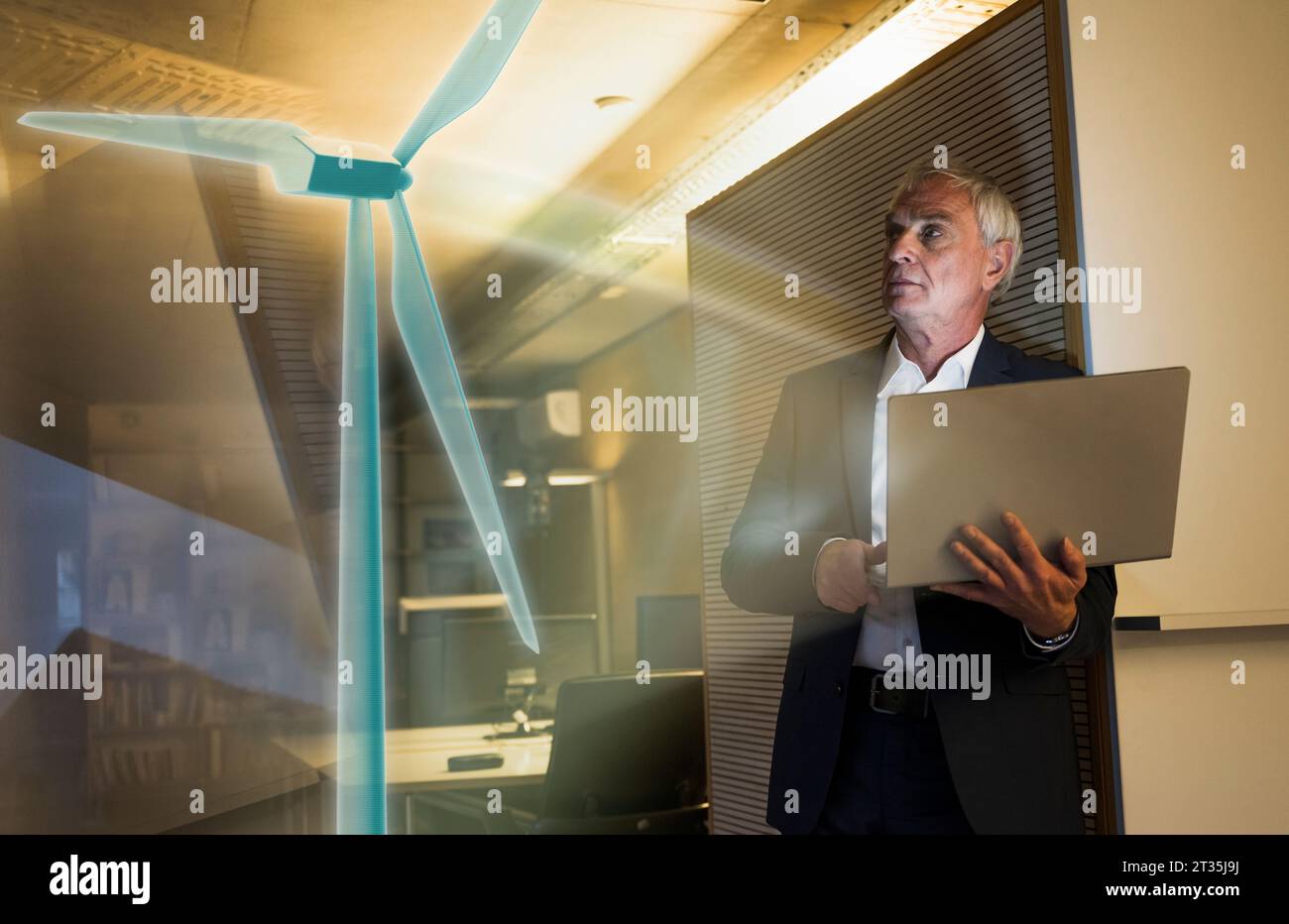 Digitales Verbundbild eines Geschäftsmannes, der futuristische Windkraftanlagen im Büro betrachtet Stockfoto