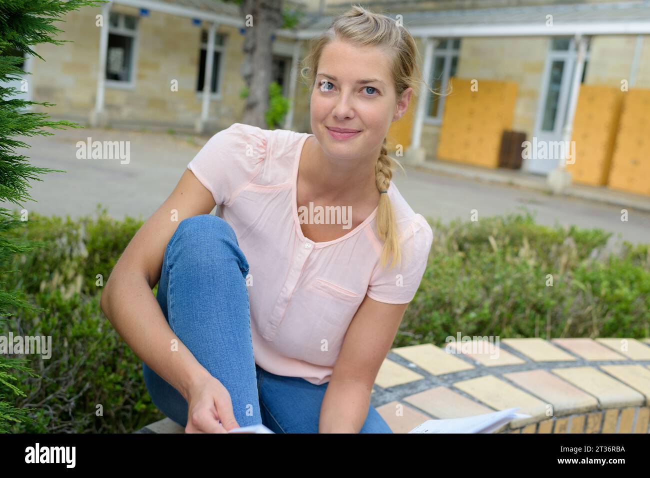 Frau mit Notizen, die draußen sitzt Stockfoto