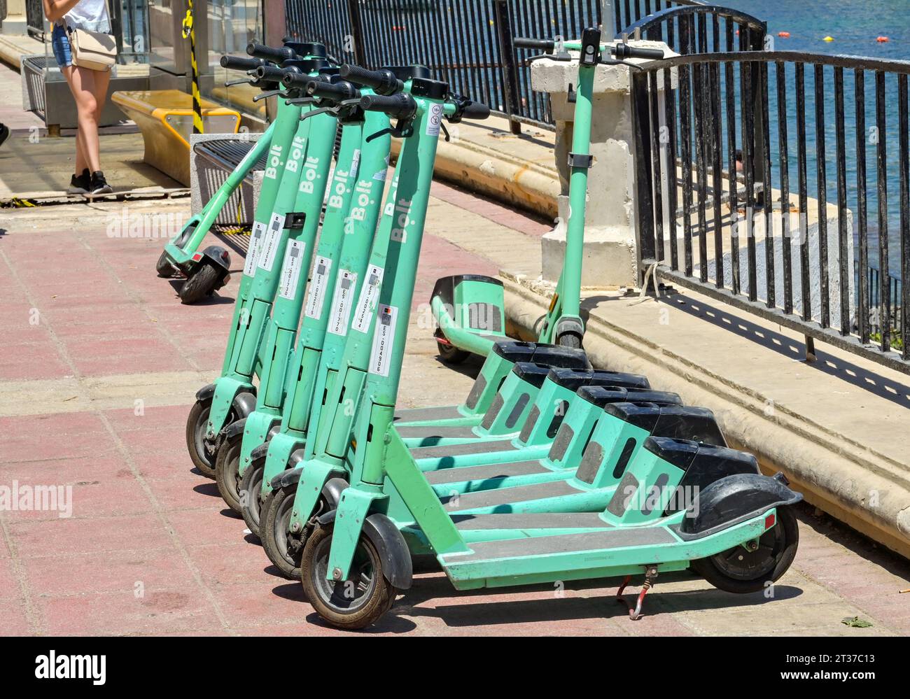 St. Julians, Malta - 2. August 2023: Reihe von Elektromotorrollern auf einem Bürgersteig in St. Julians Stockfoto
