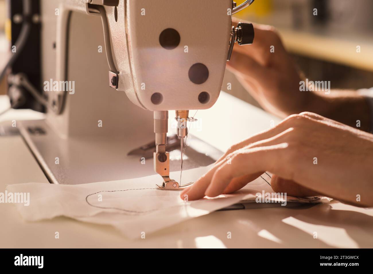 Human Hands Fashion Designer arbeitet an Nähmaschinen Nahaufnahme Arbeiten im Design Studio Textil Industriekonzept Stockfoto