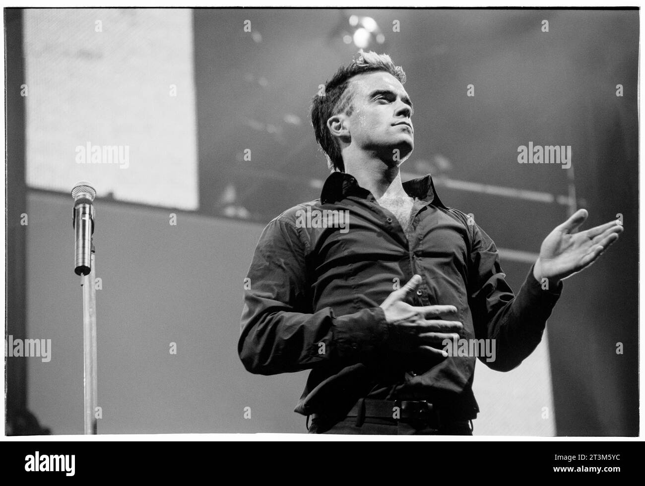 ROBBIE WILLIAMS, CARDIFF, 2001: Robbie Williams macht den Robot Dance auf seiner Hochzeiten, Barmitzvahs & Stadiums Tour im Cardiff Arms Park – Millennium Stadium in Cardiff, Wales, Großbritannien am 14. Juli 2001. Foto: Rob Watkins Stockfoto