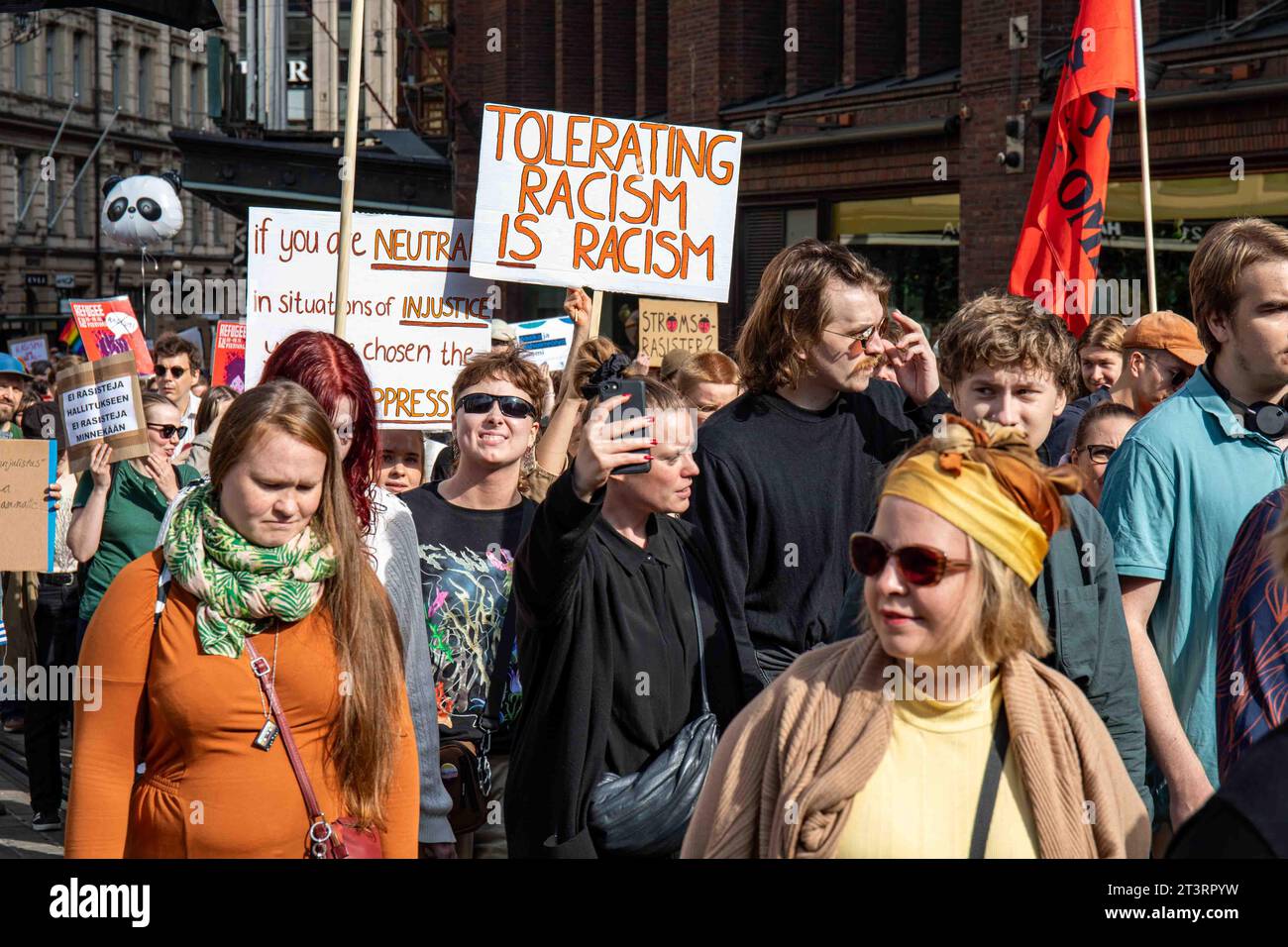 Rassismus zu tolerieren ist Rassismus. Demonstranten und handgemachte Schilder gegen mich emme vaikene! Antirassistische Demonstration in Helsinki, Finnland. Stockfoto