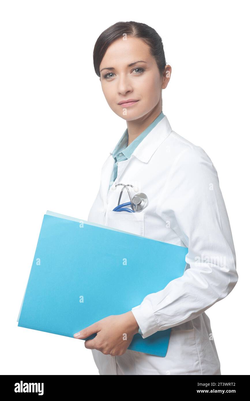 Lächelnde junge Ärztin, die medizinischen Unterlagen Datei. Stockfoto