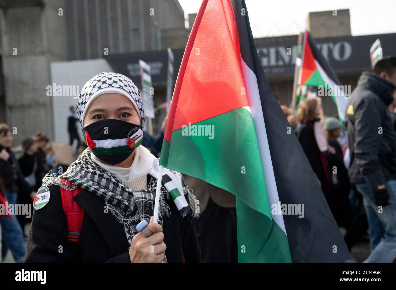 Am 28. Oktober 2023 marschierten Massen in Zentral-London und protestierten gegen die israelische Bombardierung des Gazastreifens. Eine junge Frau mit einer Flagge. Stockfoto