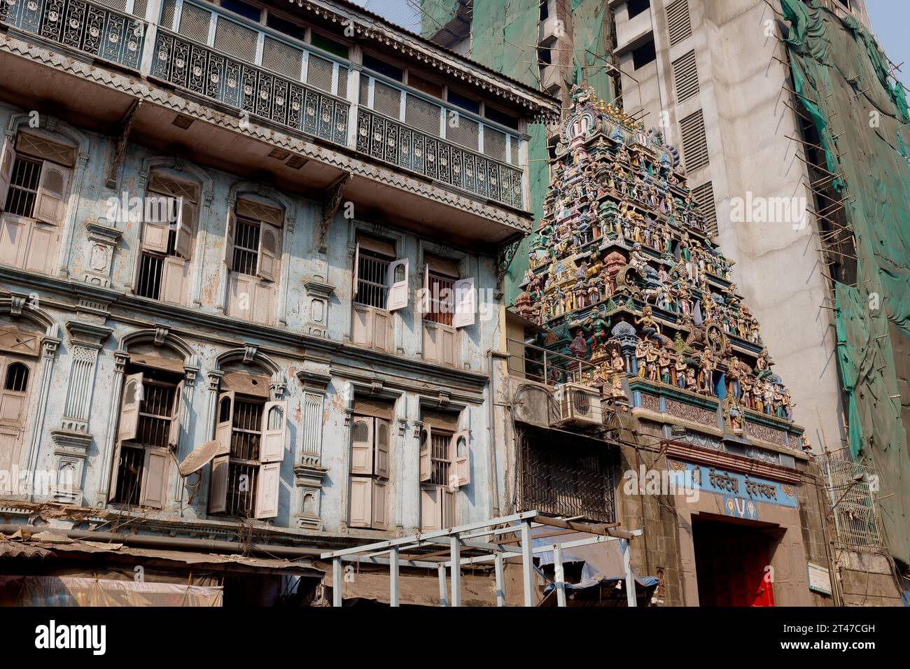 Venkatesh-Tempel im südindischen Stil (Tamil-Stil) (Hindu) neben einem großen, zerbröckelnden Wohngebäude im Bhuleshwar-Viertel in Mumbai, Indien Stockfoto