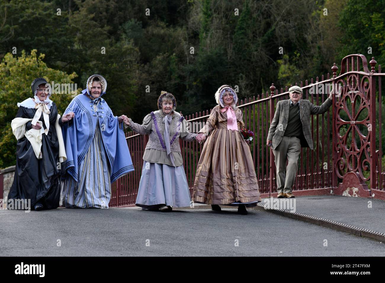 Damen in viktorianischen Kostümen in Ironbridge, Shropshire, UNESCO-Weltkulturerbe, England, Großbritannien. Kampagnen für die Brunnenrestauration. Stockfoto