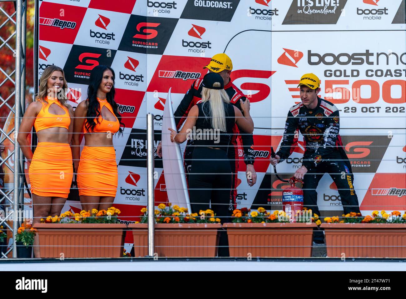 Gold Coast, Australien. 29. Oktober 2023. Brodie Kostecki von Erebus Motorsport wird von Caroline Buchanen mit dem 2. Platz ausgezeichnet, während David Reynolds sie mit dem Feuerlöscher bedroht. Quelle: James Forrester/Alamy Live News Stockfoto