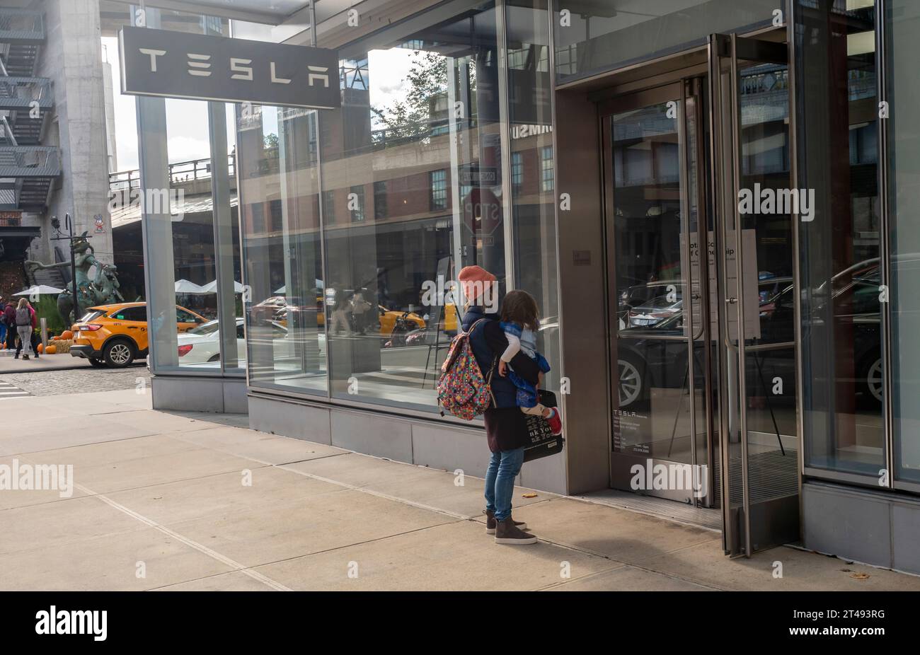 Frau und Kind vor dem Tesla Showroom im Meatpacking District in New York am Sonntag, den 22. Oktober 2023. (© Richard B. Levine) Stockfoto