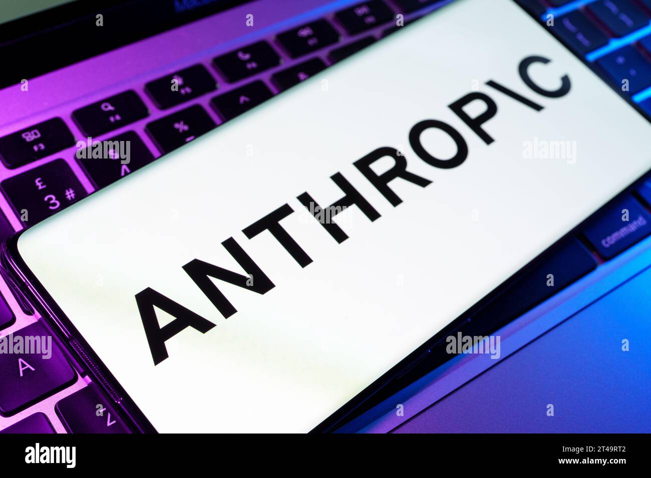 Das Logo des anthropischen KI-Forschungsunternehmens, das auf dem Smartphone zu sehen ist, wird auf dem Laptop platziert. Stafford, Vereinigtes Königreich, 29. Oktober 2023 Stockfoto