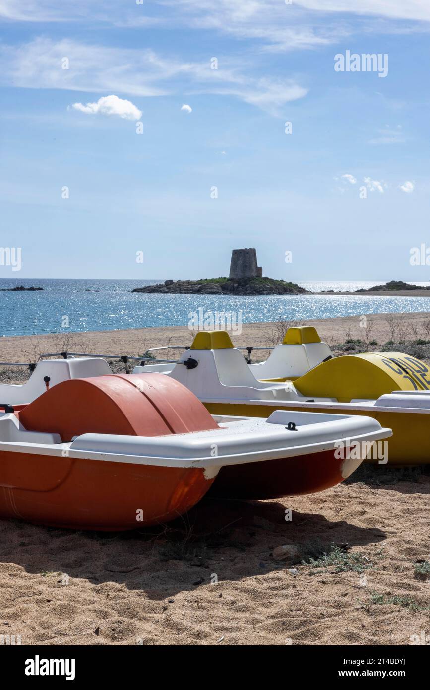 Tretboote am Strand vor dem Torre di Bari Sardo, historischer spanischer Wachturm aus dem 16. Jahrhundert, Bari Sardo, Ogliastra, Sardinien, Italien Stockfoto