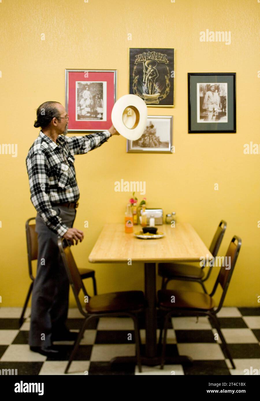 Ein Porträt eines lateinamerikanischen Mannes mit seinem Cowboyhut in einem Restaurant. Stockfoto