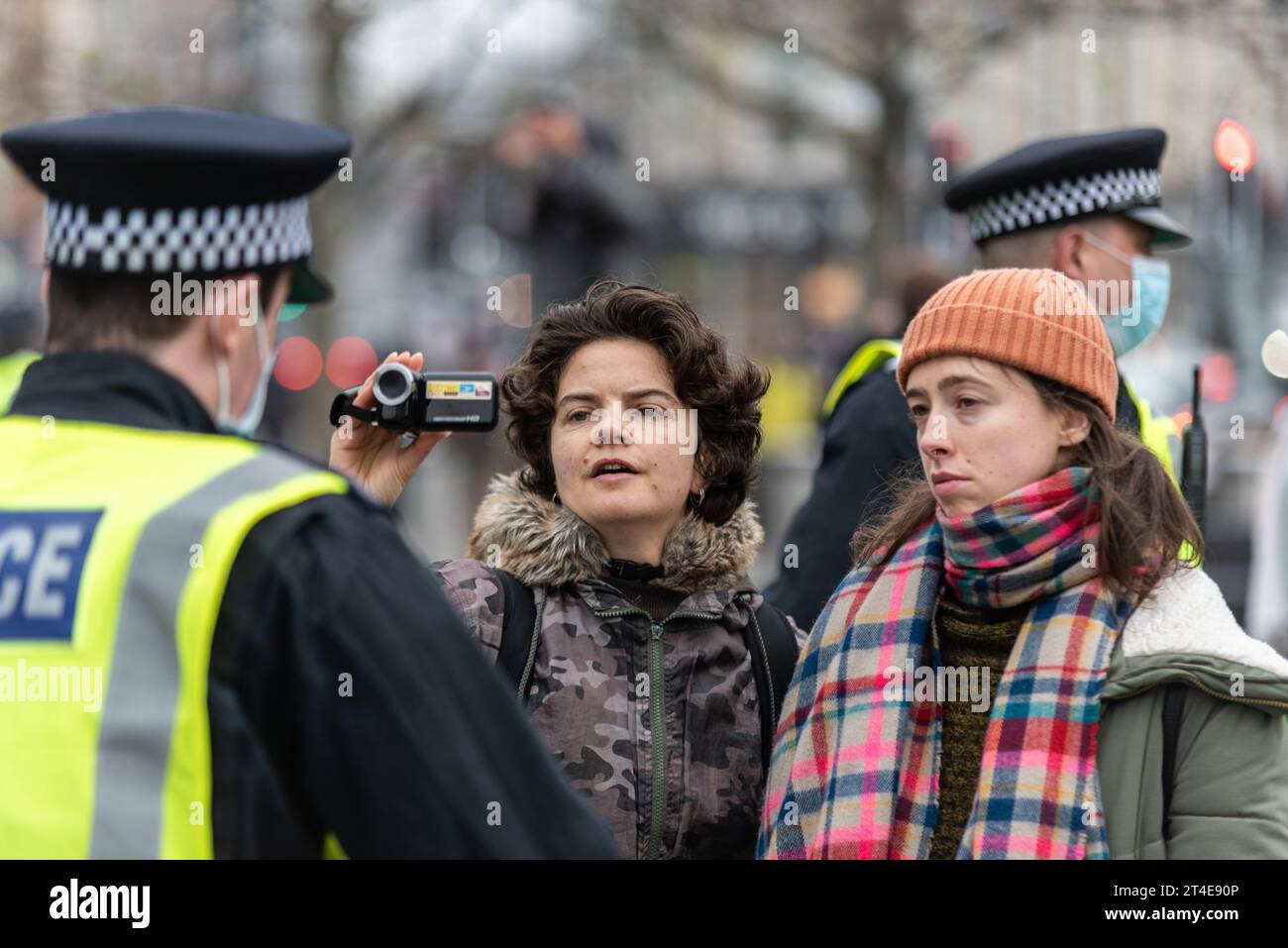 Menschen, die Polizeibeamte bei einem COVID 19-protestmarsch gegen die Abriegelung filmen, in London, Großbritannien. Palmcorder-Kamera Stockfoto