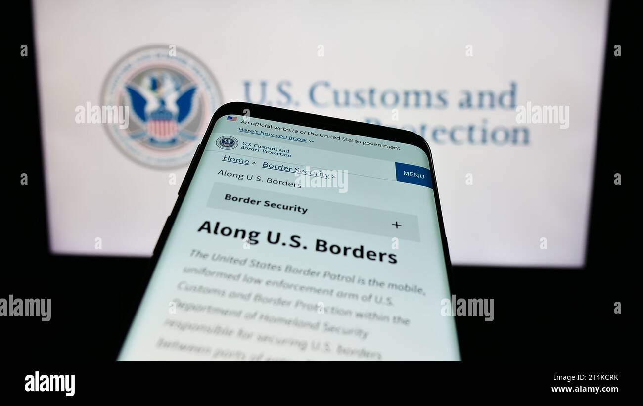 Mobiltelefon mit Website der Behörde United States Customs and Border Protection (CBP) vor dem Siegel. Fokussieren Sie sich oben links auf der Telefonanzeige. Stockfoto