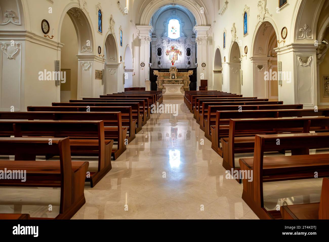 Innenraum der Pfarrkirche St. Antonius (Parrocchia Sant’Antonio) in Monopoli, Italien, mit klassischer Architektur und Marmortaufe Stockfoto