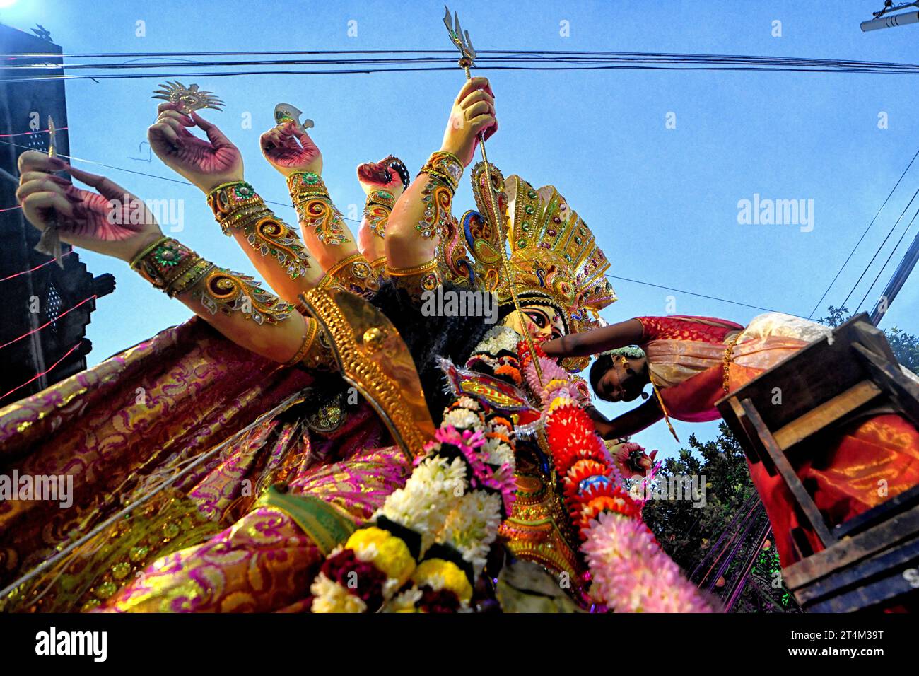 Während des Vijaya Dashami, dem letzten Tag des 10-tägigen Durgapuja Festivals, führt eine geweihte Frau Gottesdienste vor dem Göttin Durga durch. Durga Puja, ein jährliches Festival, das den Sieg des Guten über das Böse markiert, wird von Hindus in ganz Indien und im Ausland gefeiert. Es ist ein Anlass der großen Begeisterung und des Festes für die Hindus. Am letzten Tag, dem Tag von Bhashan oder Vijoya Dashami, werden Bilder und Idole in Wasser getaucht. Stockfoto