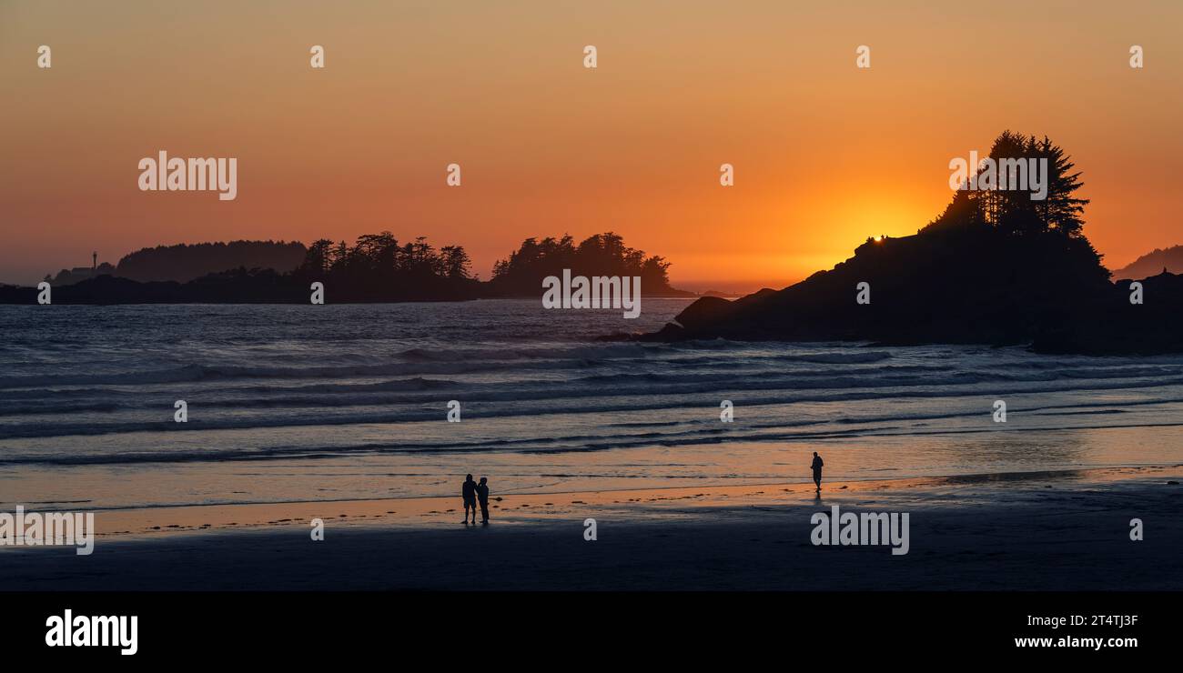 Menschen Silhouetten bei Sonnenuntergang am Cox Bay Beach und Sunset Point, Tofino, Vancouver Island, Kanada. Stockfoto