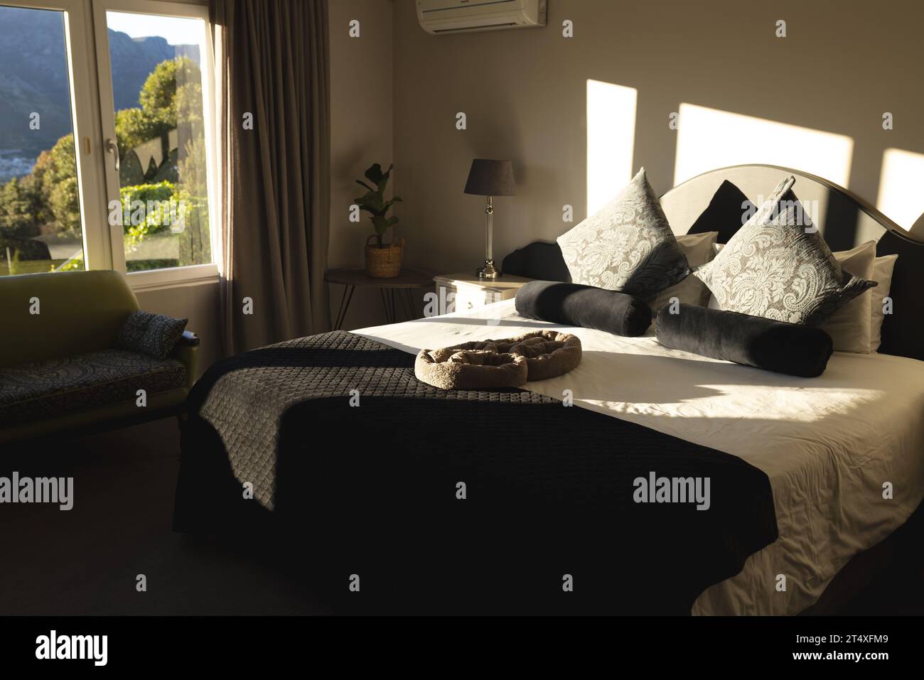 Innenausstattung des sonnigen Wohnschlafzimmers mit Doppelbett und Bergblick, Kopierraum Stockfoto