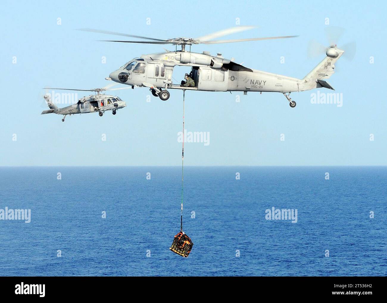 1003224649B-216 CARIBBEAN SEA, (22. März 2010) ein MH-60S Sea Hawk Hubschrauber, der der Helicopter Sea Combat Squadron (HSC) 22 zugewiesen ist, beförderte an Bord des amphibischen Mehrzweckschiffs USS Bataan (LHD 5) Munition während einer vertikalen Auffüllung. Bataan führt Operationen vor der Küste Haitis durch und unterstützt die Operation Unified Response, nachdem ein Erdbeben der Stärke 7,0 schwere Schäden in und um Port-au-Prince 12. Januar verursacht hat. Stockfoto