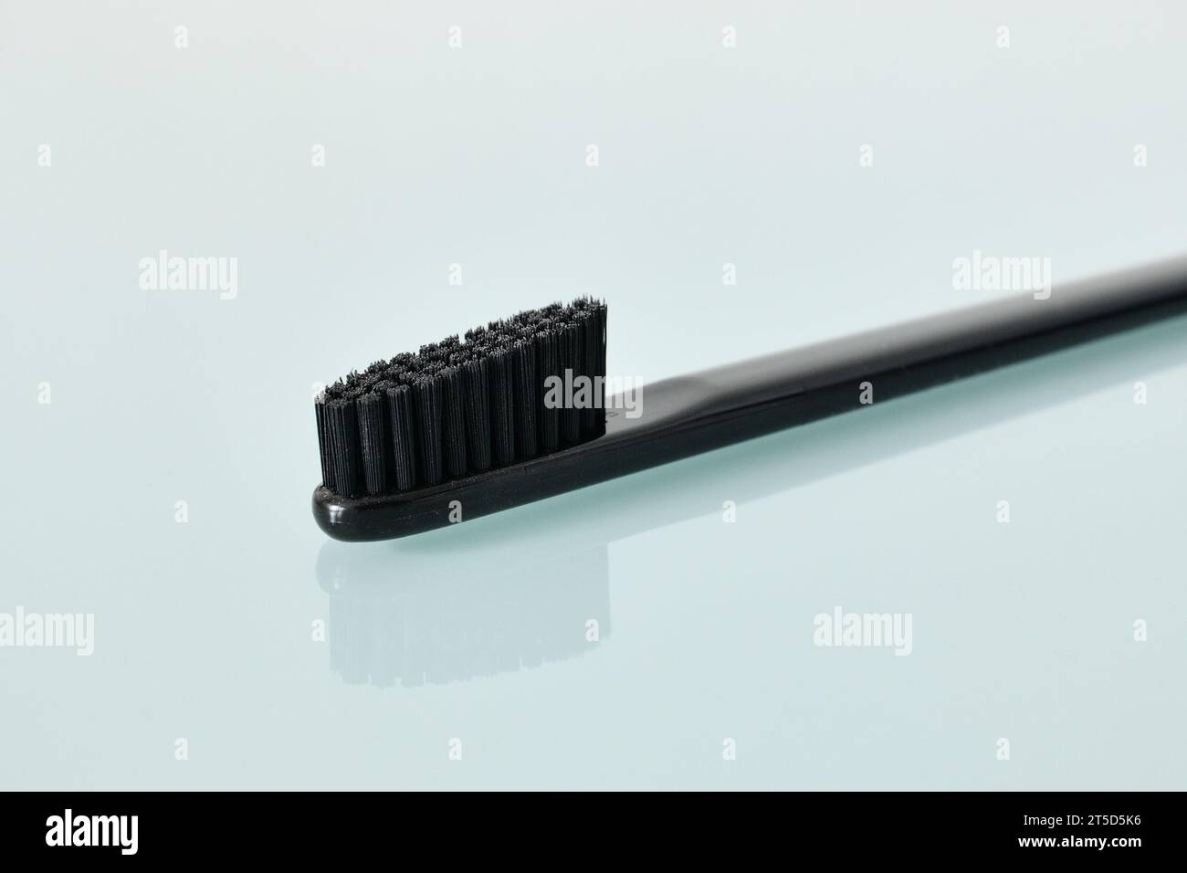 Schwarzer Zahnbürste auf hellblauem Hintergrund Stockfoto
