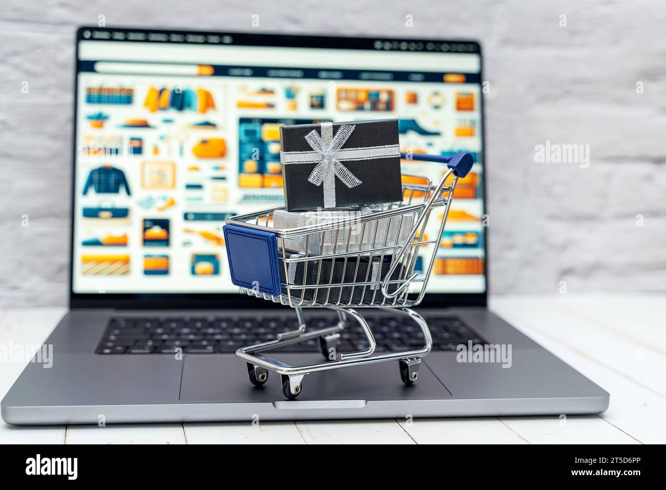 Augsburg, Bayern, Deutschland - 4. November 2023: Pakete mit Geschenken in einem Einkaufswagen auf einem Laptop Computer vor einer Online-Shop Website. Geschenke Einkaufen und bestellen im Internet Konzept *** Geschenkpakete im Warenkorb auf einem Laptop vor einer Online-Shop-Website. Geschenkeinkauf und -Bestellung im Internet Konzept Credit: Imago/Alamy Live News Stockfoto