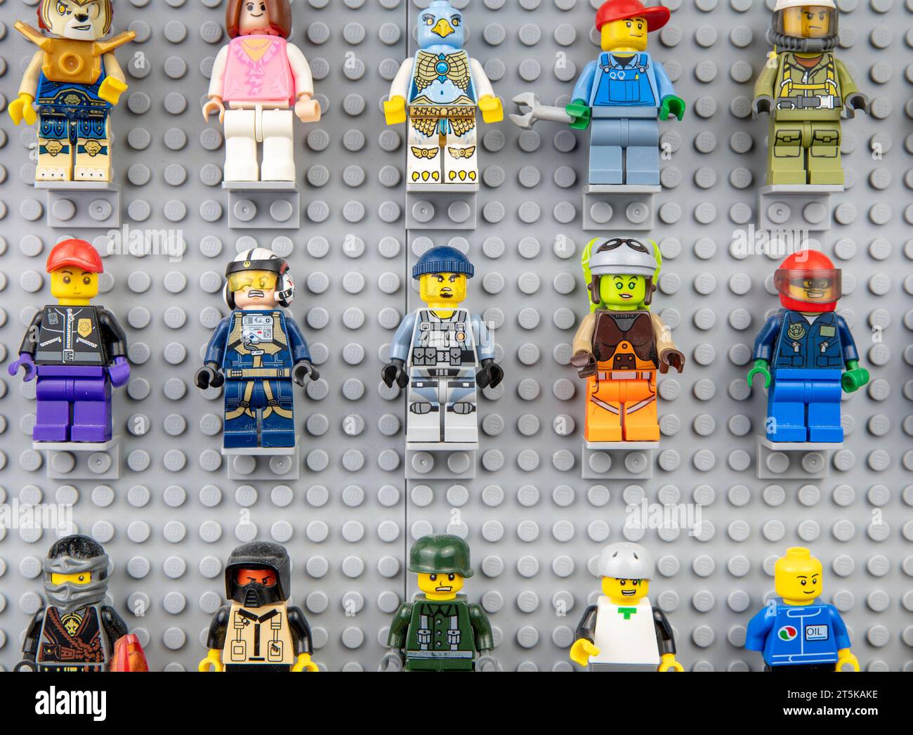 Nova Bana, Slowakei - 5. November 2023 : Lego-Minifiguren an der Wand. LEGO® Minifiguren auf Lego Grundplatten in Reihe. Stockfoto