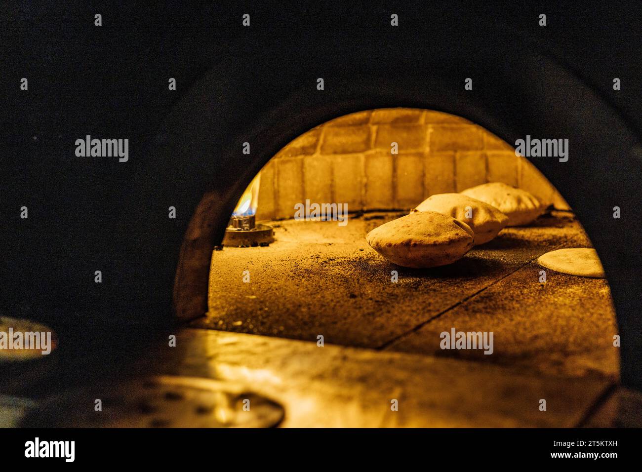 Backen und Servieren von Pitta brad, Pizza und frischem Brot im Abendessen Restaurant und bei gesellschaftlichen Veranstaltungen. Stockfoto
