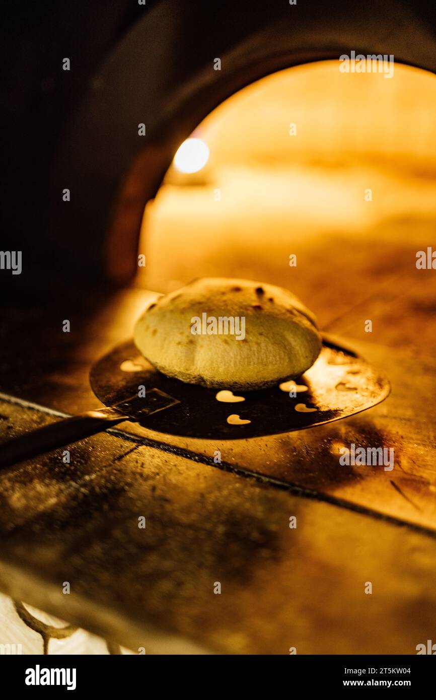 Backen und Servieren von Pitta brad, Pizza und frischem Brot im Abendessen Restaurant und bei gesellschaftlichen Veranstaltungen. Stockfoto
